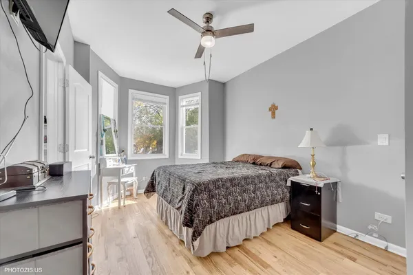 a bedroom with a bed and a large window
