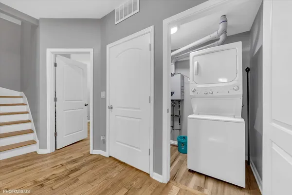 a view of a hallway with wooden floor and closet