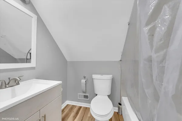 a white toilet sitting next to a bathroom sink