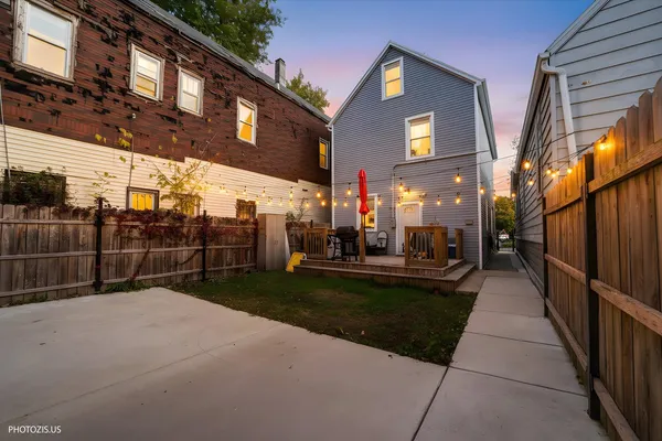 a view of a brick house with a yard in the background