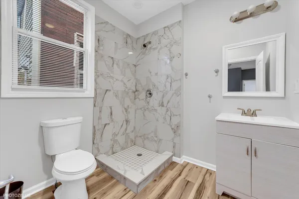 a bathroom with a toilet sink shower and mirror