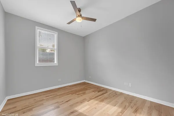 a view of a room with wooden floor and window