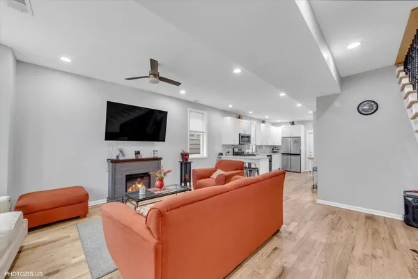 a living room with furniture a flat screen tv and a fireplace