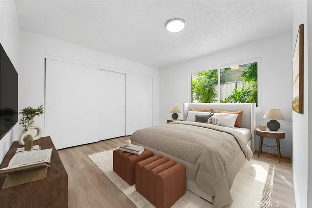 a room with a bed and a potted plant