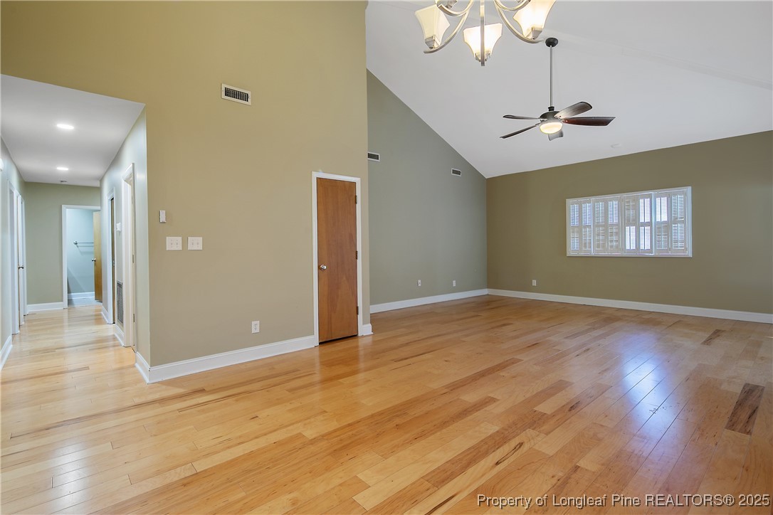 2118 Winterlochen Road Fayetteville, NC 28305 - Photo 12 of 50 a view of an empty room with wooden floor and a ceiling fan