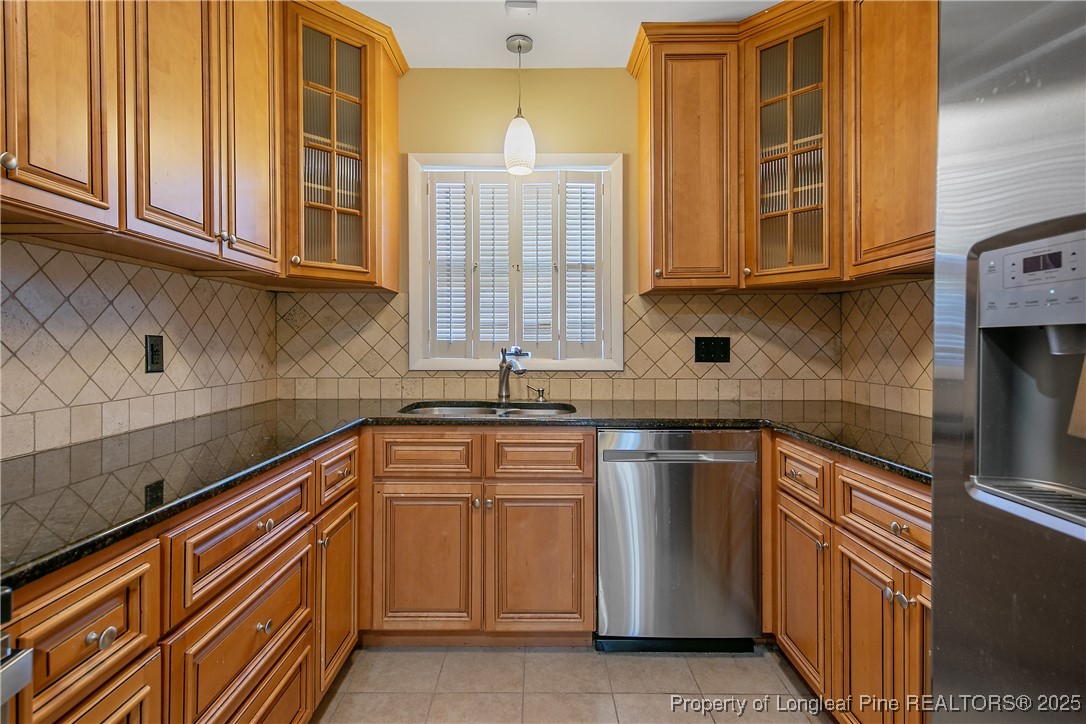 2118 Winterlochen Road Fayetteville, NC 28305 - Photo 17 of 50 a kitchen with stainless steel appliances granite countertop a sink and cabinets