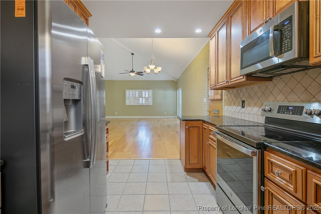 2118 Winterlochen Road Fayetteville, NC 28305 - Photo 18 of 50 a kitchen with a refrigerator and a sink