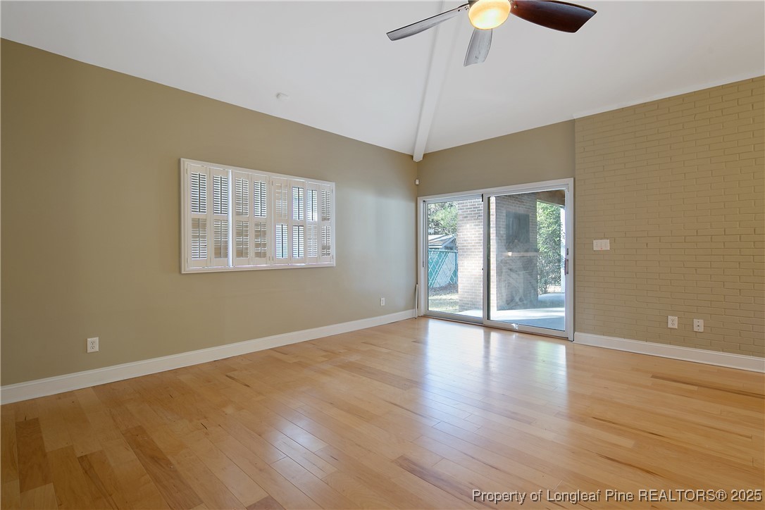 2118 Winterlochen Road Fayetteville, NC 28305 - Photo 21 of 50 a view of an empty room with wooden floor fireplace and a window