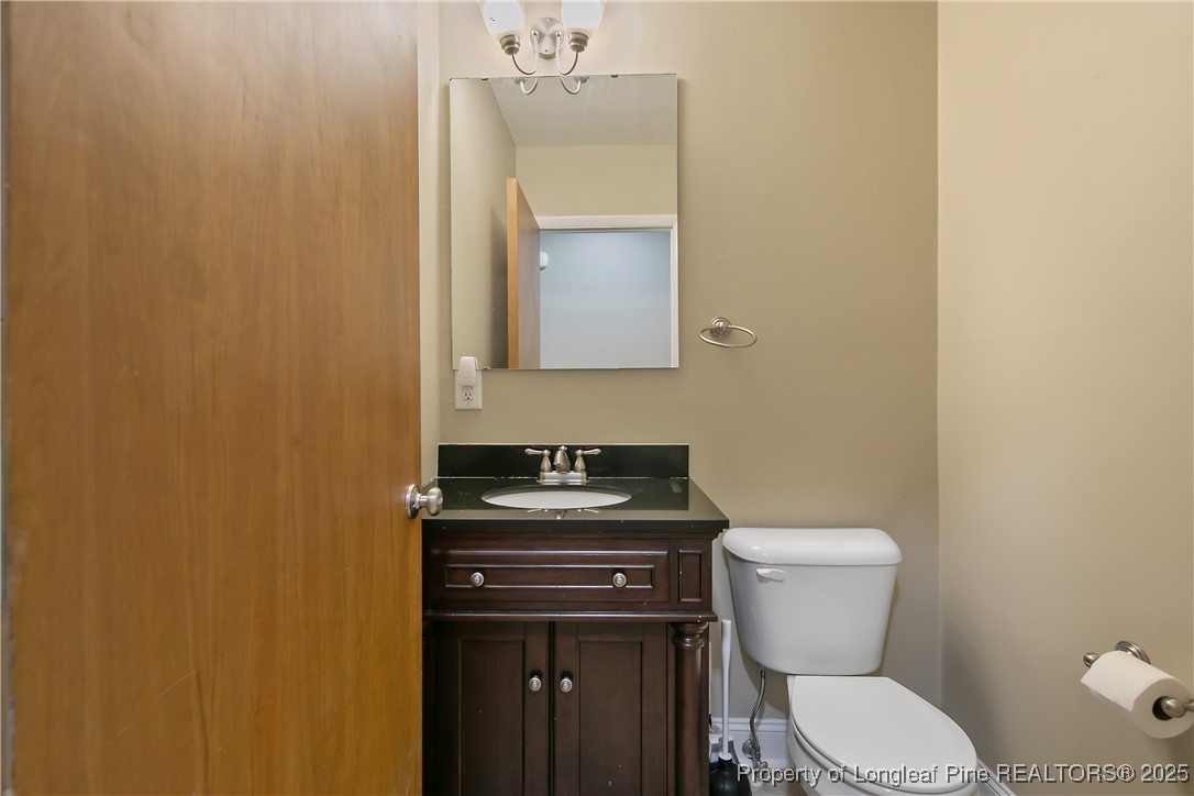 2118 Winterlochen Road Fayetteville, NC 28305 - Photo 25 of 50 a bathroom with a toilet a sink and mirror