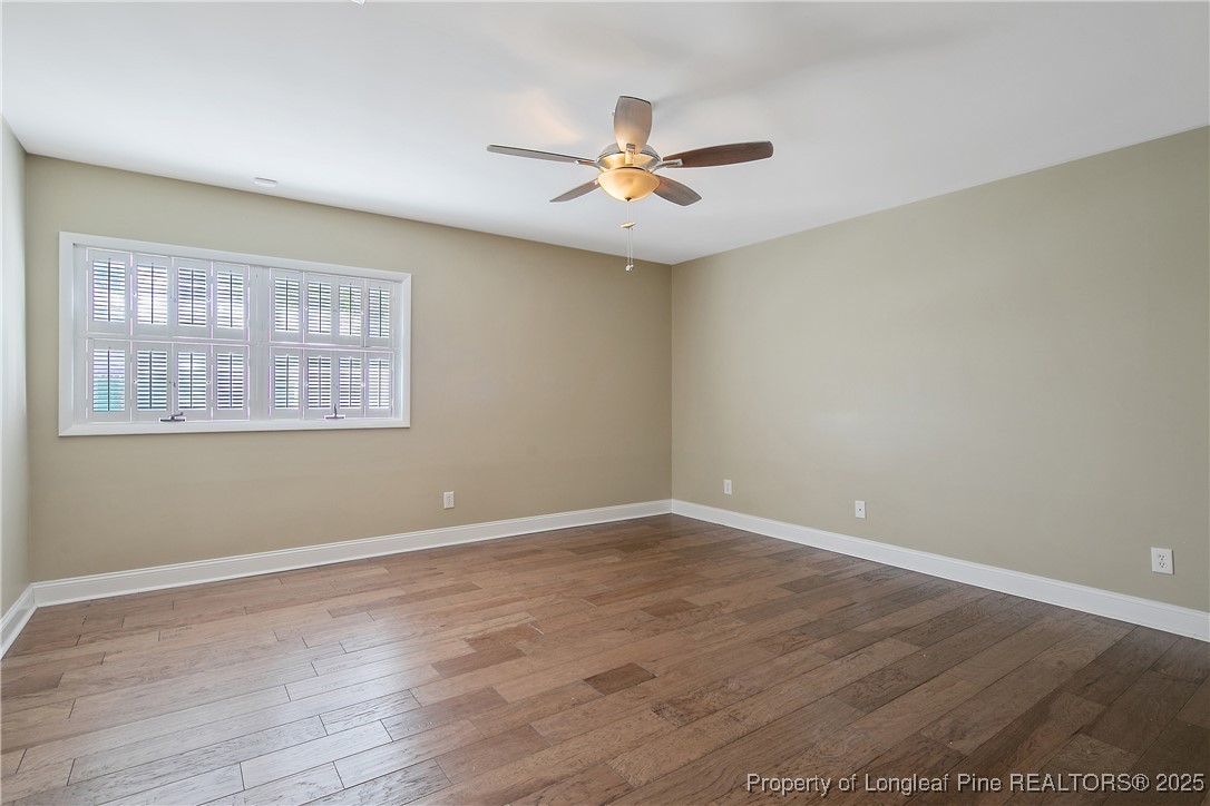 2118 Winterlochen Road Fayetteville, NC 28305 - Photo 26 of 50 a view of an empty room with wooden floor and a window