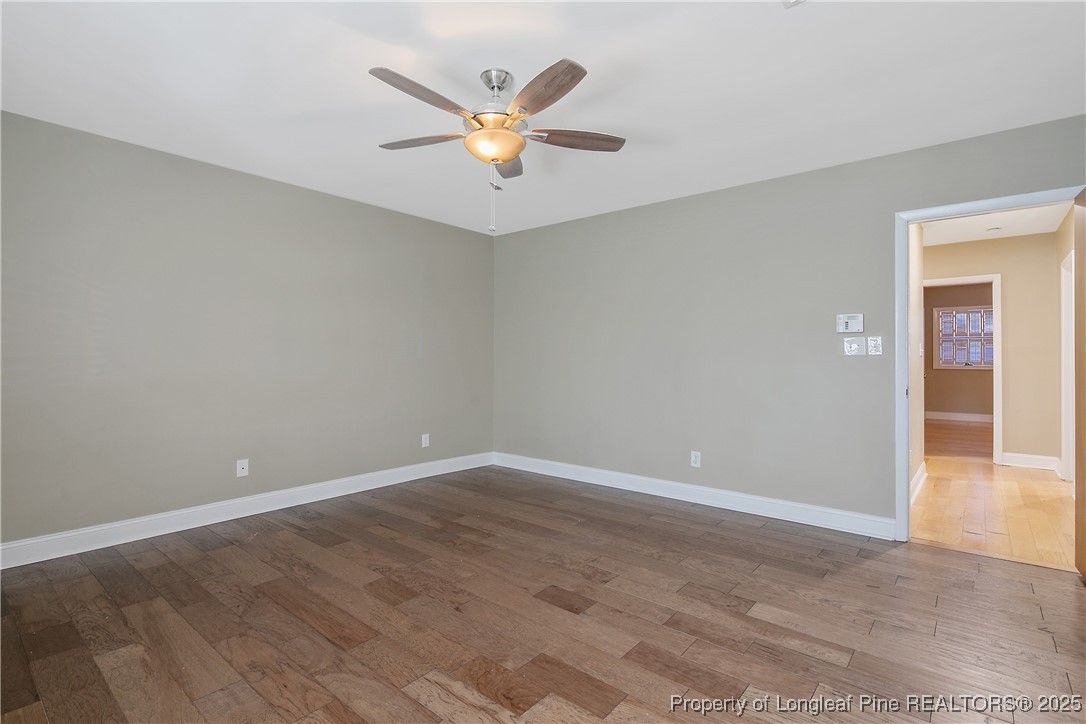 2118 Winterlochen Road Fayetteville, NC 28305 - Photo 27 of 50 a view of an empty room with wooden floor and a ceiling fan