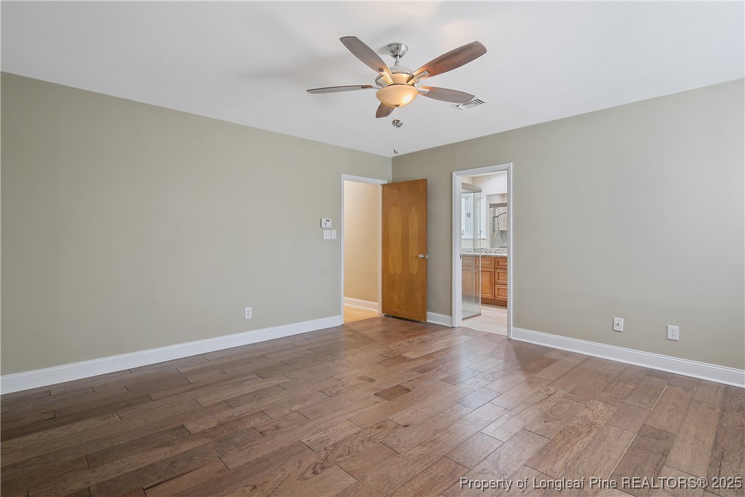 2118 Winterlochen Road Fayetteville, NC 28305 - Photo 28 of 50 an empty room with wooden floor and ceiling fan