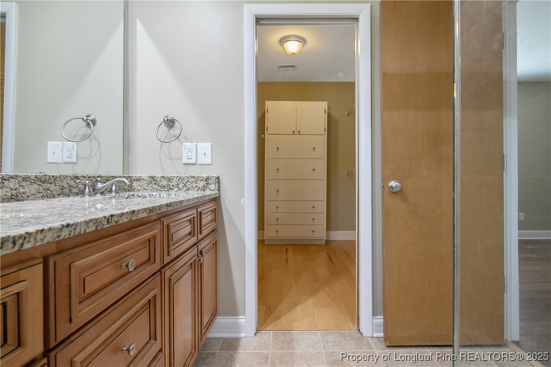 2118 Winterlochen Road Fayetteville, NC 28305 - Photo 33 of 50 a bathroom with a granite countertop sink and a mirror
