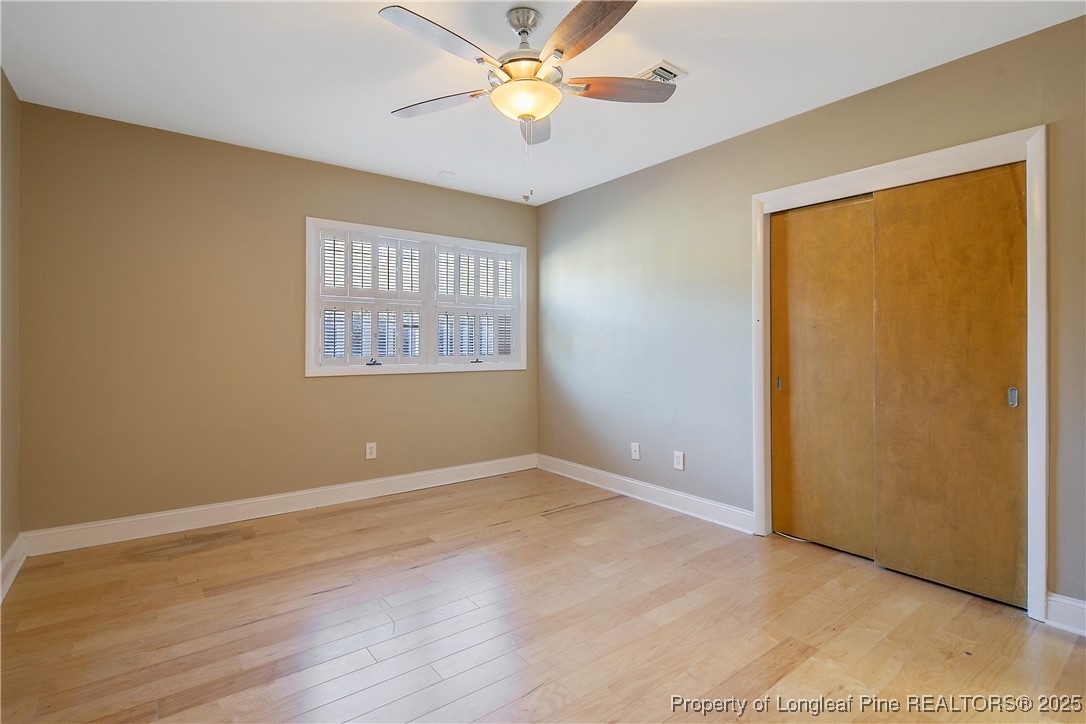 2118 Winterlochen Road Fayetteville, NC 28305 - Photo 36 of 50 an empty room with a window and a ceiling fan