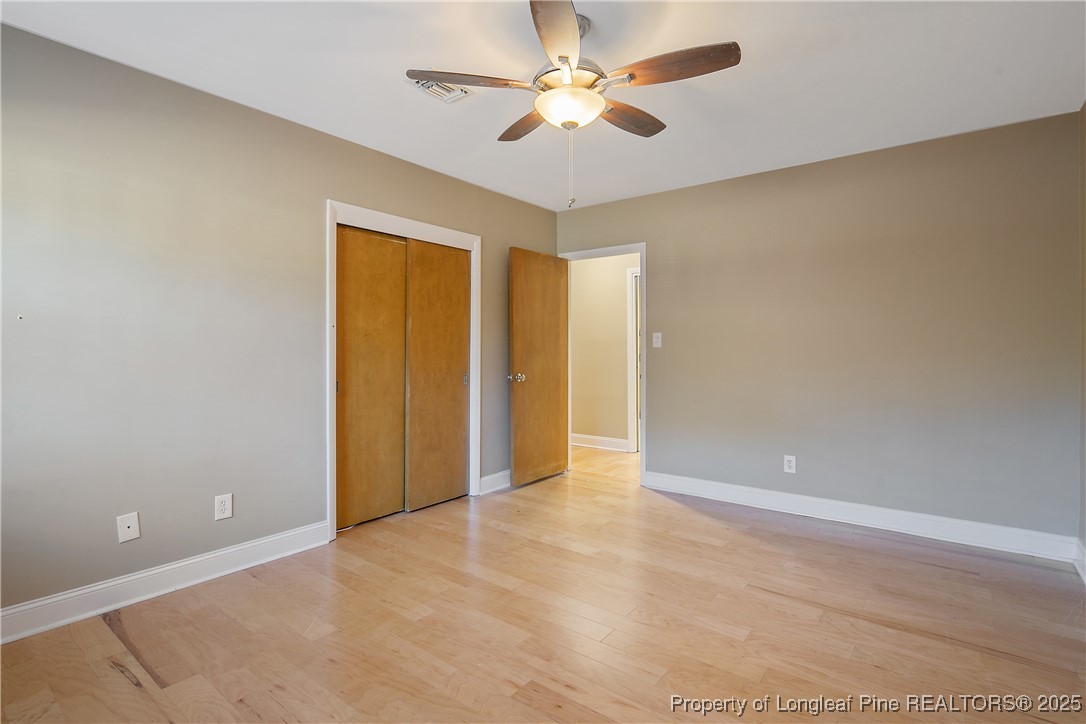 2118 Winterlochen Road Fayetteville, NC 28305 - Photo 37 of 50 an empty room with closet and a ceiling fan
