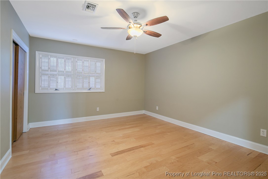2118 Winterlochen Road Fayetteville, NC 28305 - Photo 43 of 50 an empty room with windows and ceiling fan