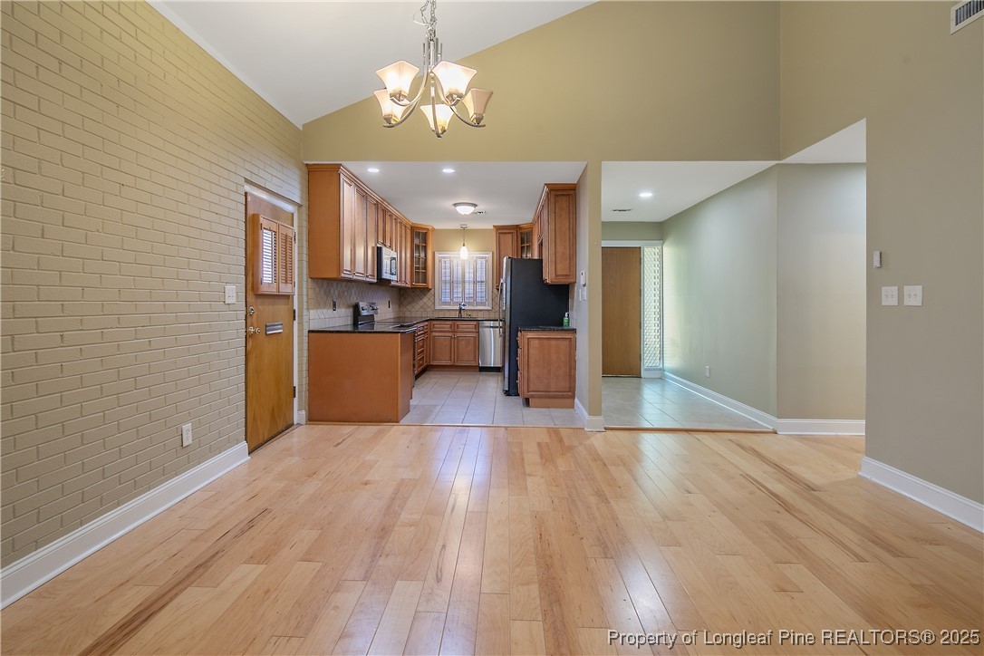 2118 Winterlochen Road Fayetteville, NC 28305 - Photo 10 of 50 a view of a kitchen with a sink stainless steel appliances and cabinets