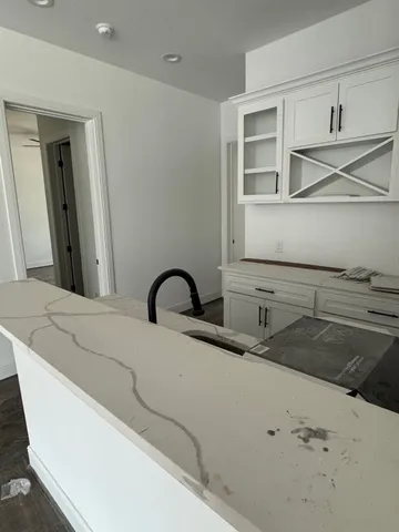 a bathroom with a granite countertop sink toilet and mirror