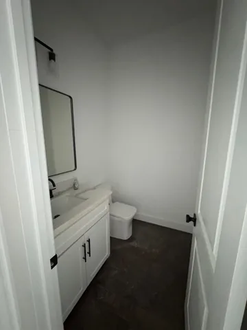 an empty room with windows and ceiling fan