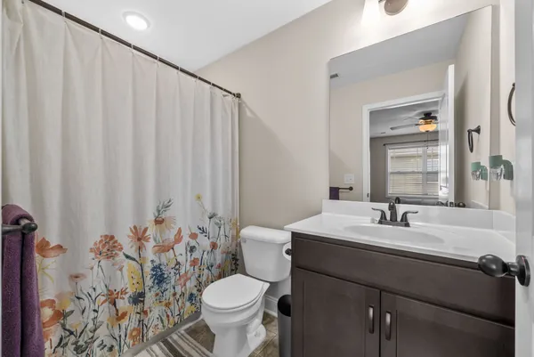 a bathroom with a sink toilet and mirror
