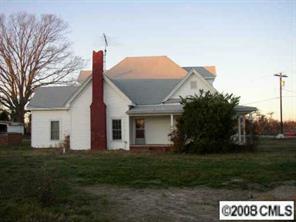 2134 Triplett Road Mount Ulla, NC 28125 - Photo 2 of 8 a front view of a house with a garden and yard