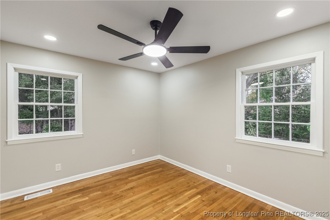 321 Summerhill Road Fayetteville, NC 28303 - Photo 14 of 26 an empty room with wooden floor and windows