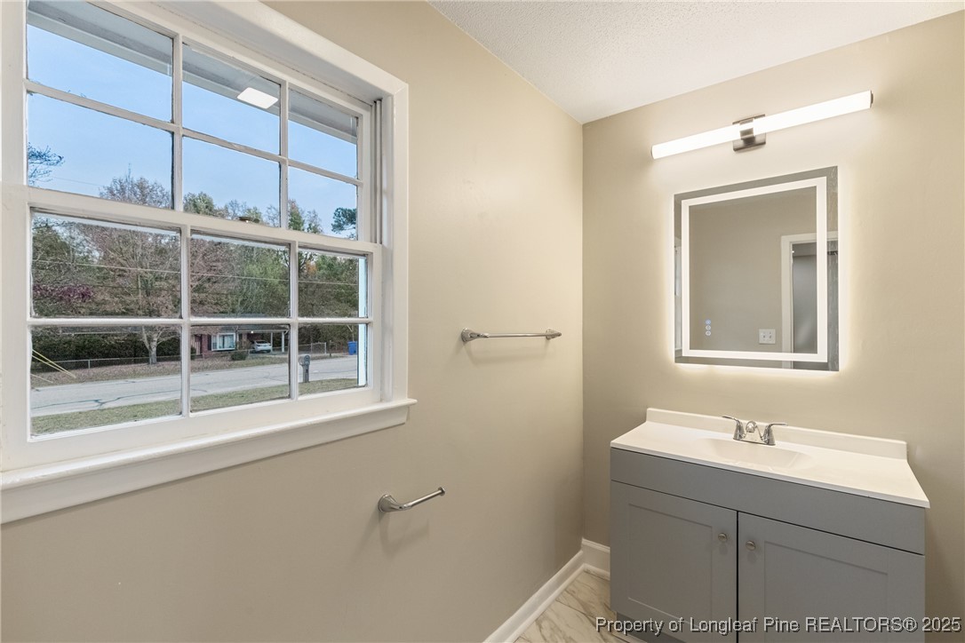 321 Summerhill Road Fayetteville, NC 28303 - Photo 18 of 26 a bathroom with a sink toilet and shower