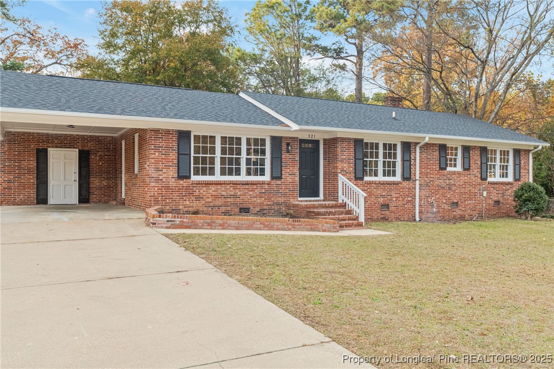 321 Summerhill Road Fayetteville, NC 28303 - Photo 2 of 26 front view of a house with a yard