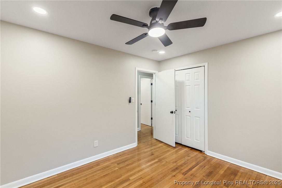321 Summerhill Road Fayetteville, NC 28303 - Photo 22 of 26 an empty room with wooden floor and ceiling fan