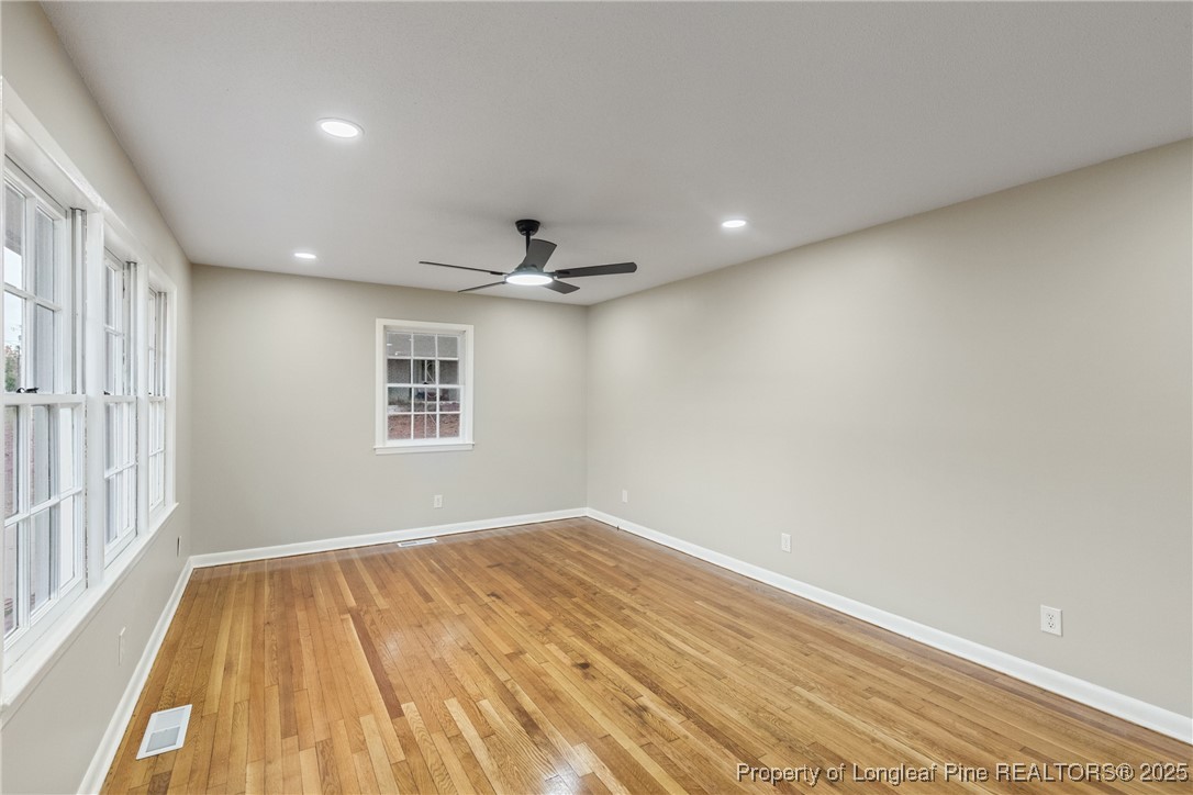 321 Summerhill Road Fayetteville, NC 28303 - Photo 4 of 26 a view of empty room with wooden floor and fan
