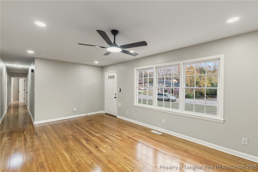 321 Summerhill Road Fayetteville, NC 28303 - Photo 5 of 26 a view of an empty room with a window and wooden floor