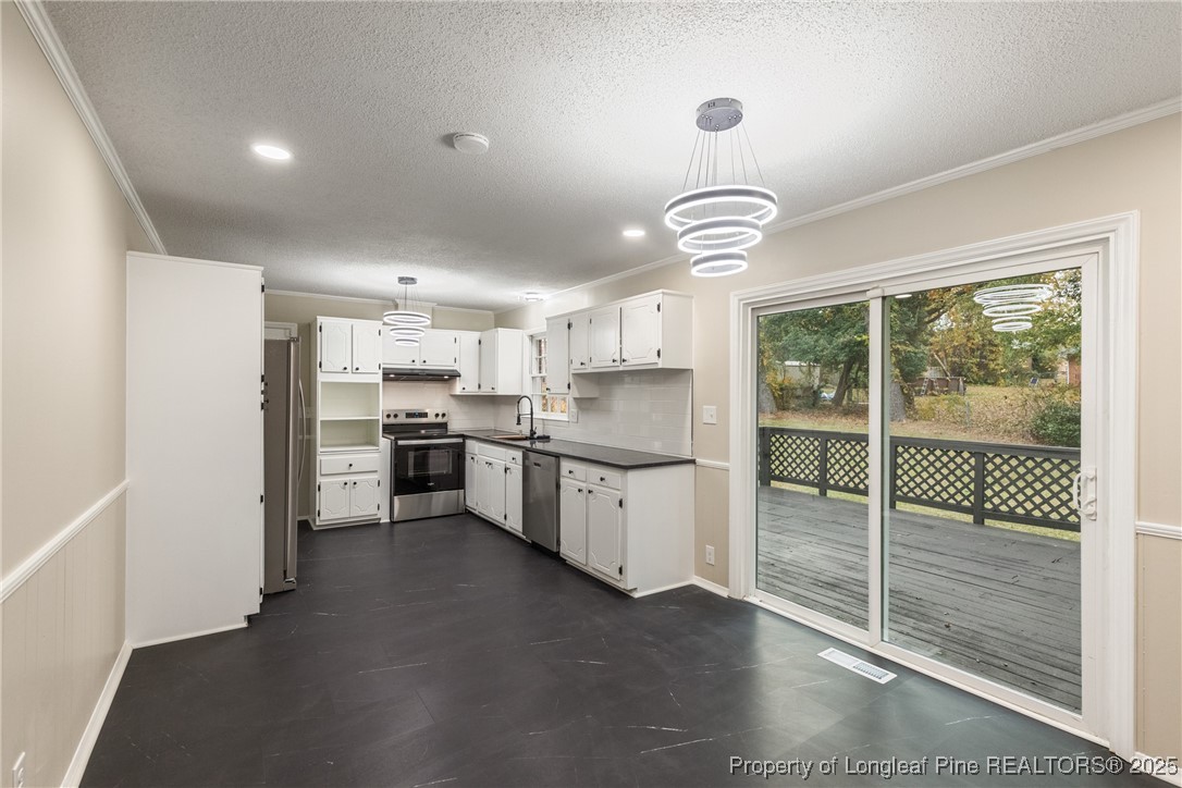 321 Summerhill Road Fayetteville, NC 28303 - Photo 7 of 26 a kitchen with stainless steel appliances granite countertop a stove a refrigerator a sink and a cabinets