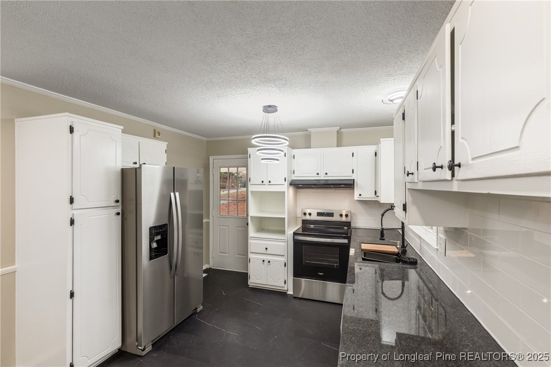 321 Summerhill Road Fayetteville, NC 28303 - Photo 9 of 26 a kitchen with stainless steel appliances a refrigerator sink and stove