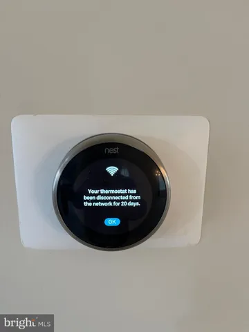 a view of an empty room with a chandelier fan