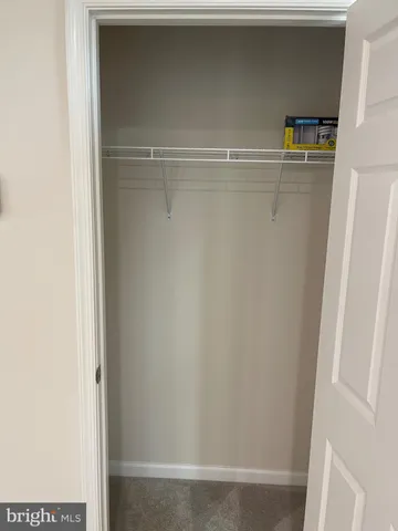 a view of a room with a ceiling fan