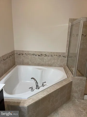 an empty room with closet and fan