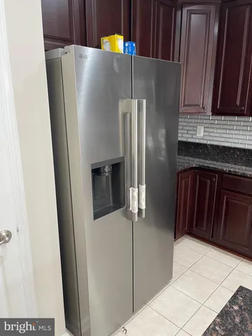 a kitchen with metallic refrigerator freezer and a dishwasher