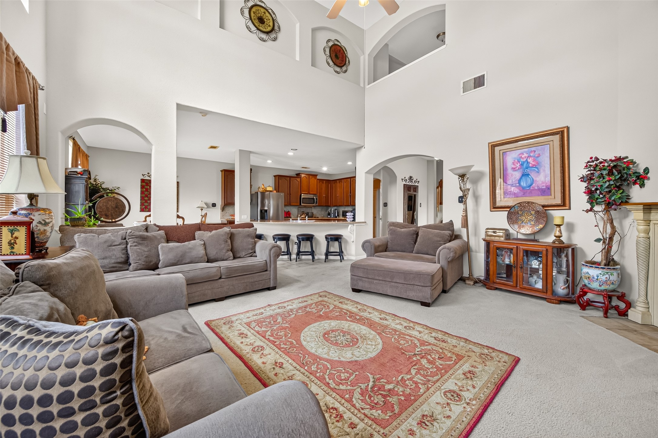 22007 Bridgestone Hawk Court Spring, TX 77388 - Photo 15 of 50 Soaring ceilings elevate the main living area, punctuated by architectural cutouts and elevated decorative niches that add dimension to the expansive interior.