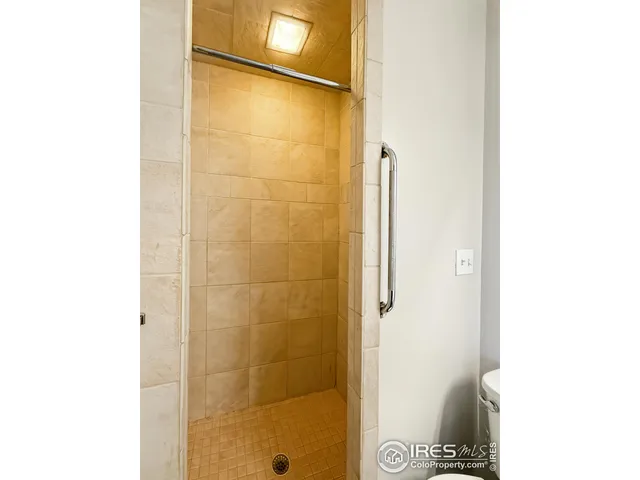 a bathroom with a shower and a sink