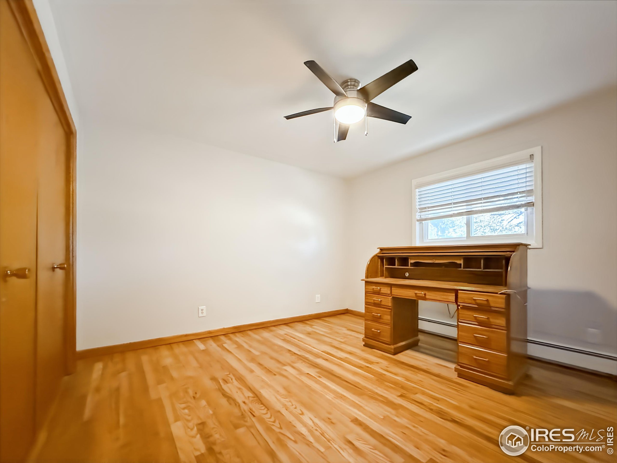 1695 6th Street Limon, CO 80828 - Photo 13 of 32 a view of a livingroom with wooden floor and a ceiling fan