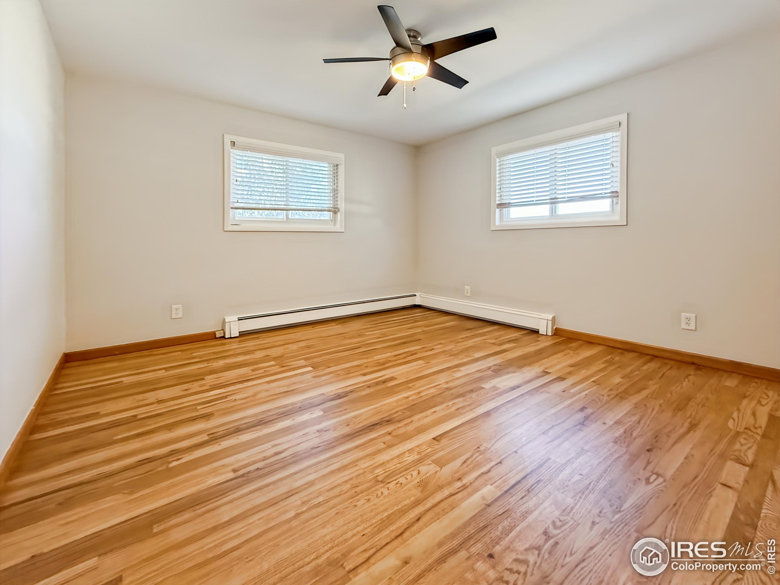 1695 6th Street Limon, CO 80828 - Photo 14 of 32 a view of empty room with wooden floor and fan
