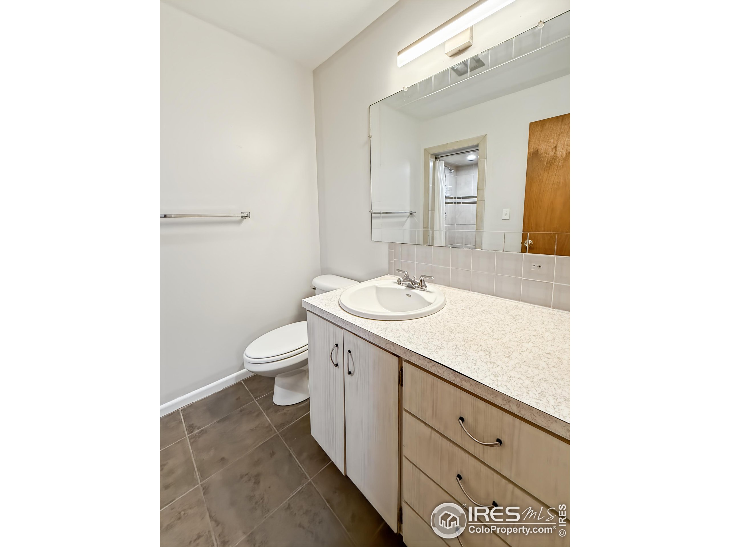1695 6th Street Limon, CO 80828 - Photo 16 of 32 a bathroom with a sink a toilet and mirror