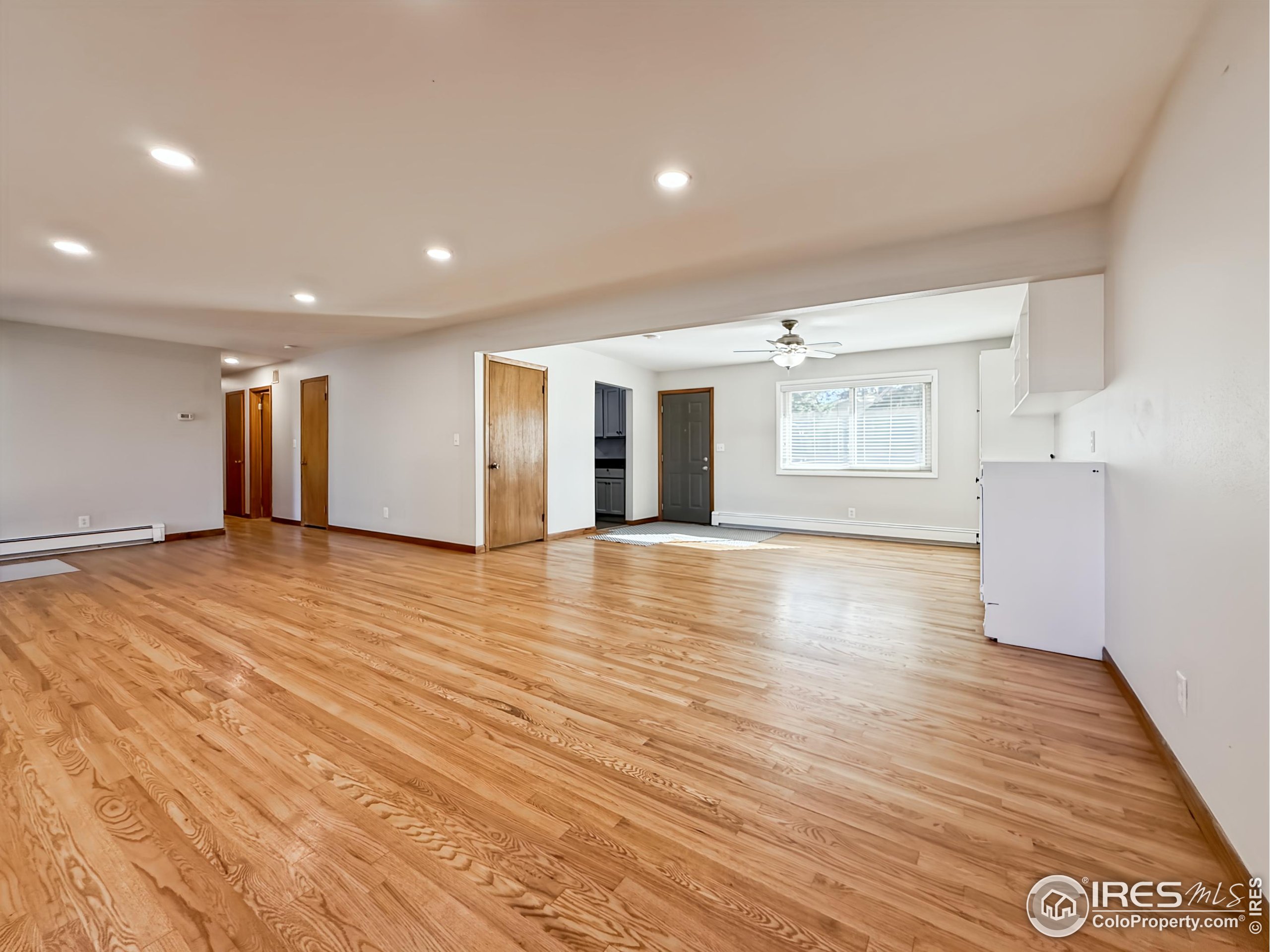 1695 6th Street Limon, CO 80828 - Photo 2 of 32 an empty room with wooden floor and windows