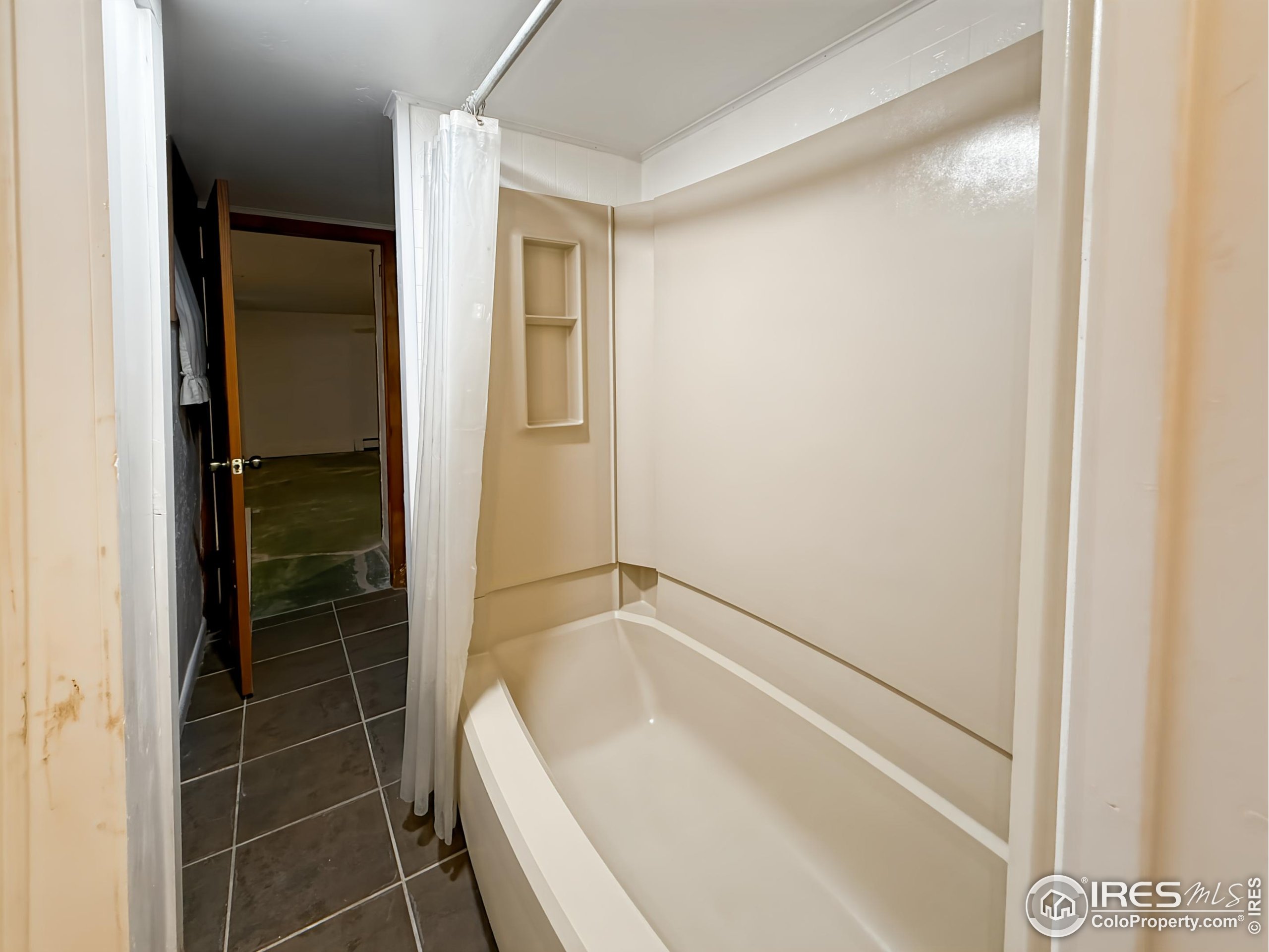 1695 6th Street Limon, CO 80828 - Photo 26 of 32 a bathroom with a bathtub and a shower