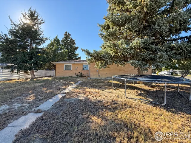 a view of a house with yard and sitting area