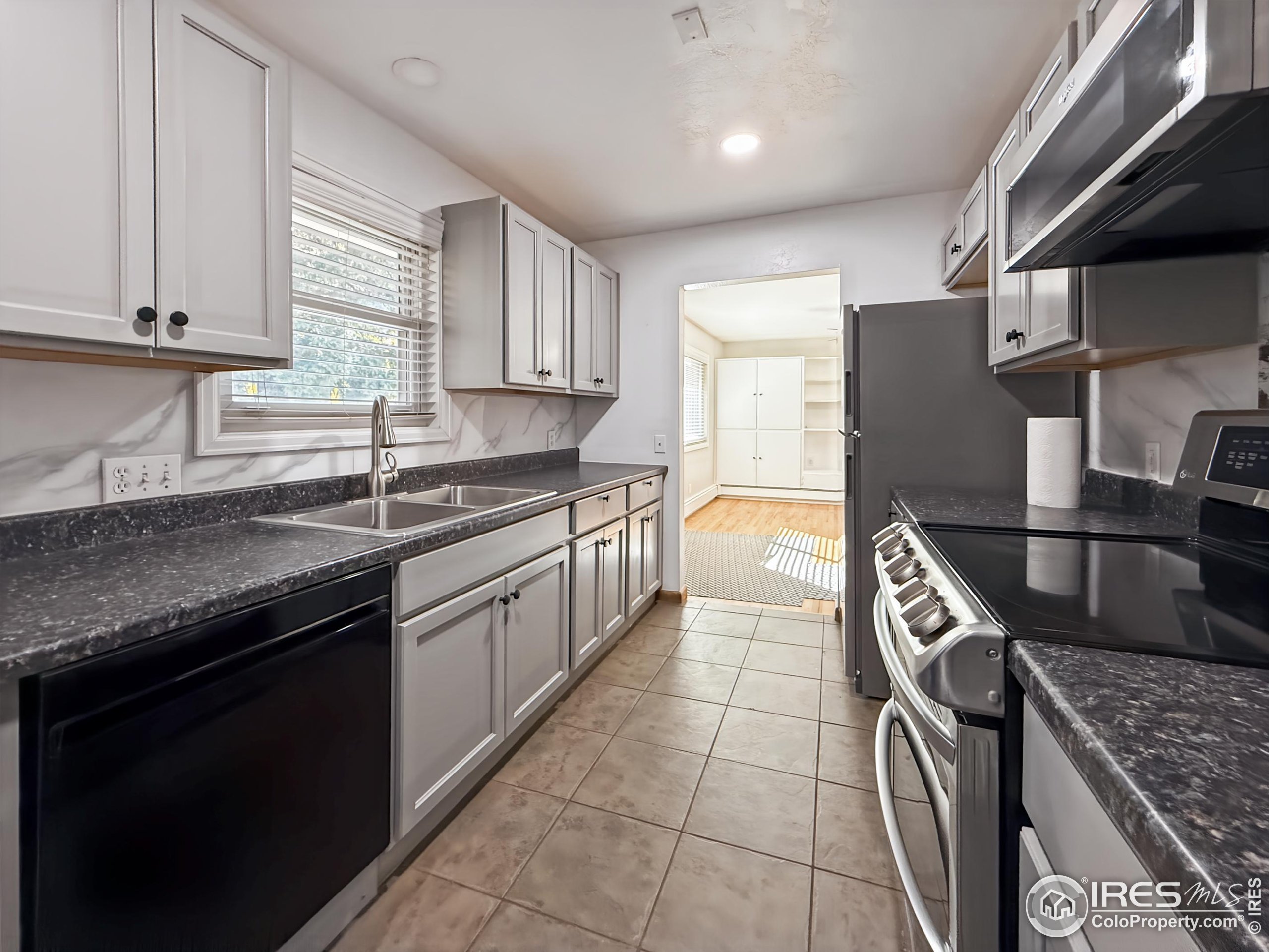1695 6th Street Limon, CO 80828 - Photo 6 of 32 a kitchen with stainless steel appliances granite countertop a sink stove and cabinets