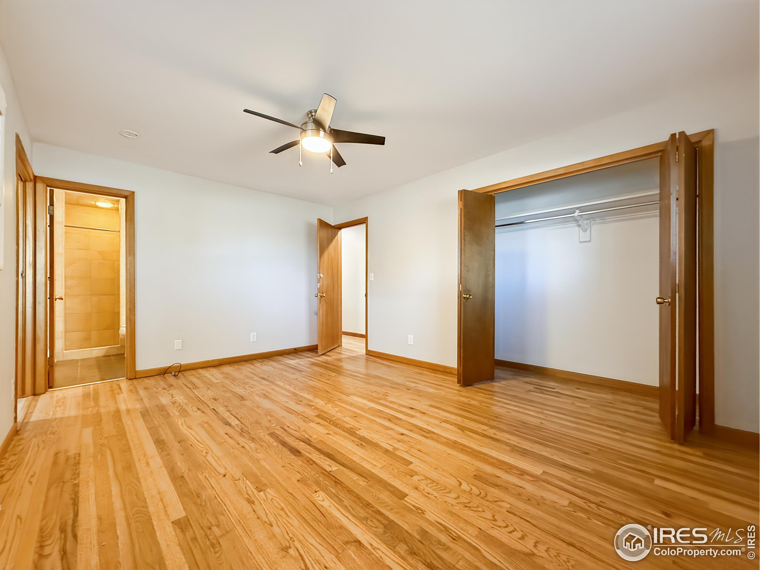 1695 6th Street Limon, CO 80828 - Photo 7 of 32 a view of empty room with wooden floor and fan