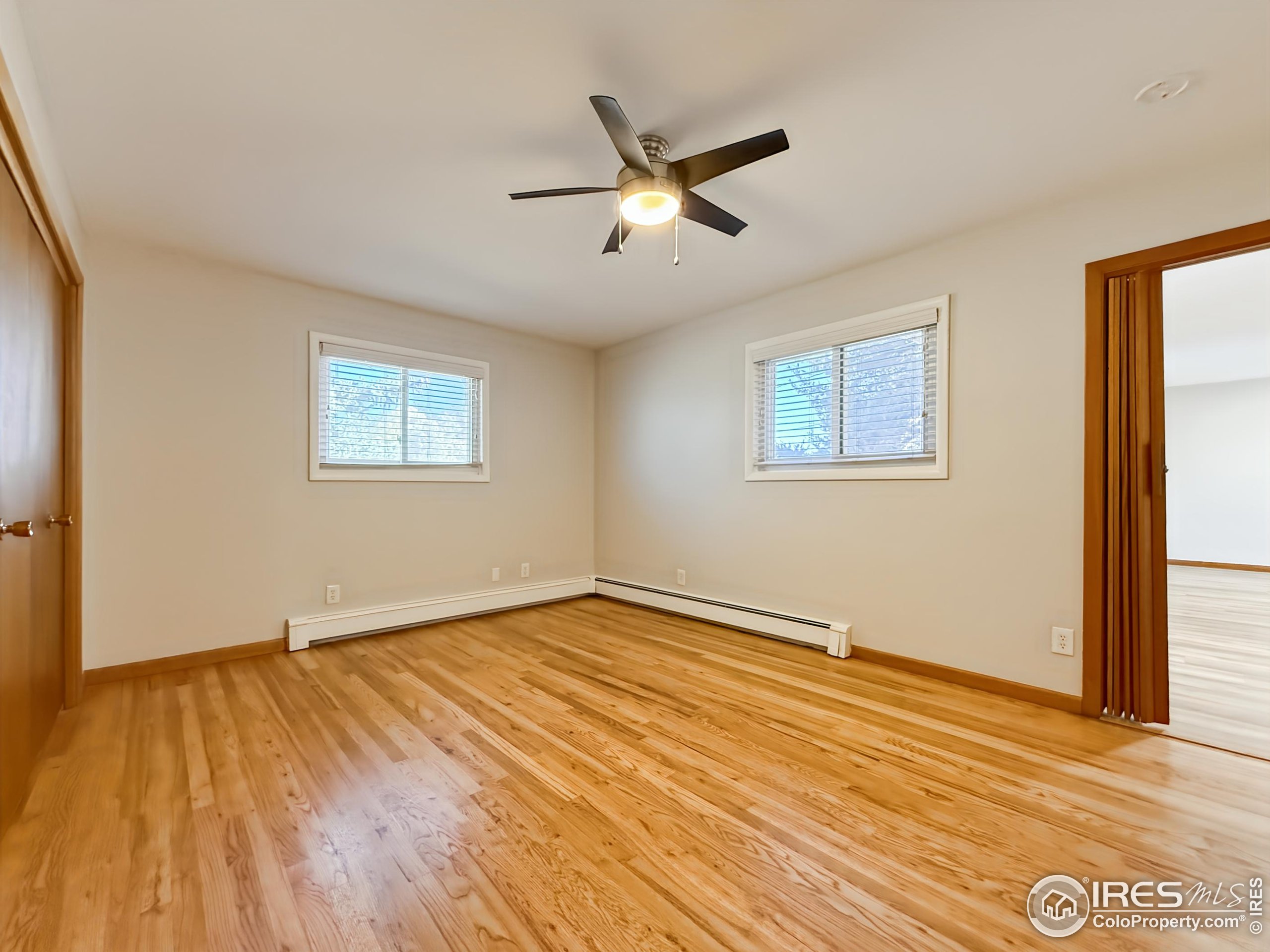 1695 6th Street Limon, CO 80828 - Photo 8 of 32 a view of an empty room with wooden floor and a window