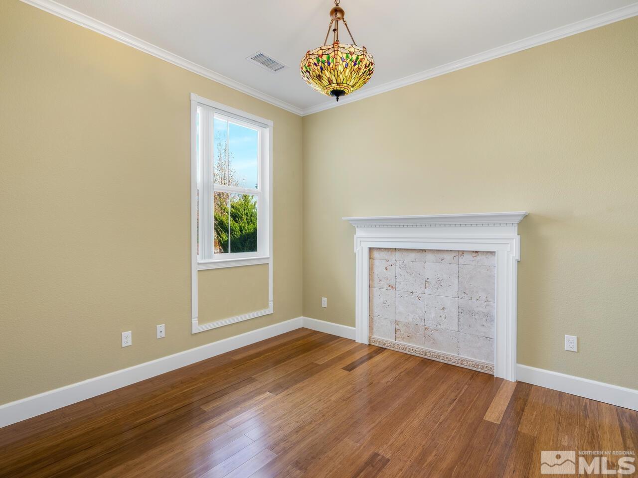 2080 Whitecliff Drive Reno, NV 89521 - Photo 14 of 21 an empty room with wooden floor cabinet and windows