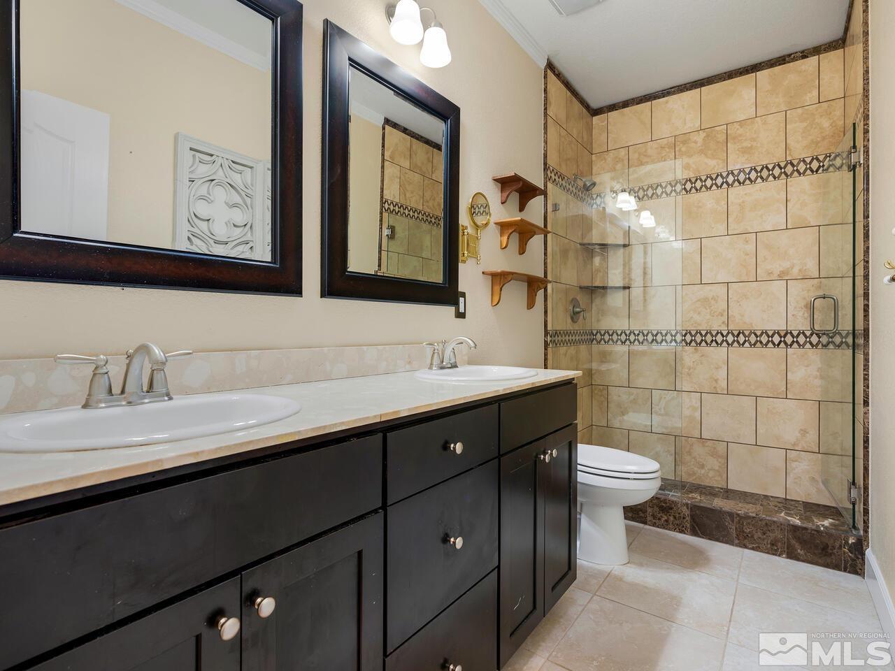 2080 Whitecliff Drive Reno, NV 89521 - Photo 17 of 21 a bathroom with a double vanity sink and a mirror